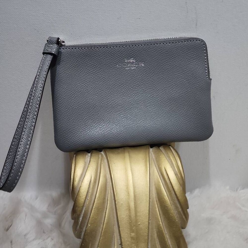 Coach Corner Zip Wristlet in a grey crossgrain leather.